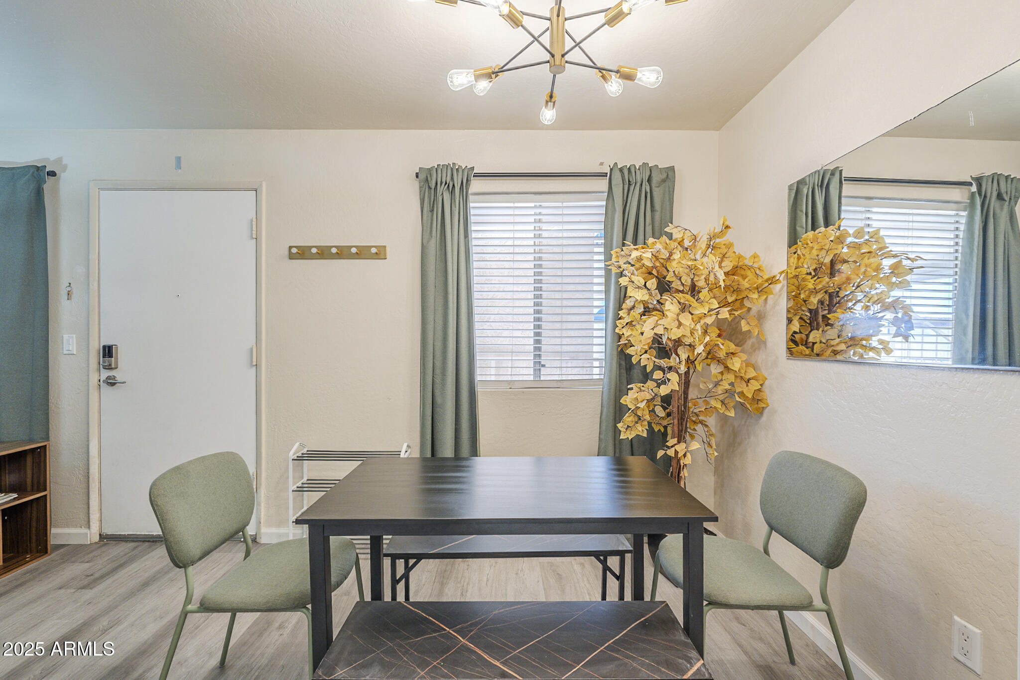 12123 West Bell Road, Unit 260 Surprise, AZ 85378 - Photo 7 of 29 a view of a dining room with furniture and wooden floor