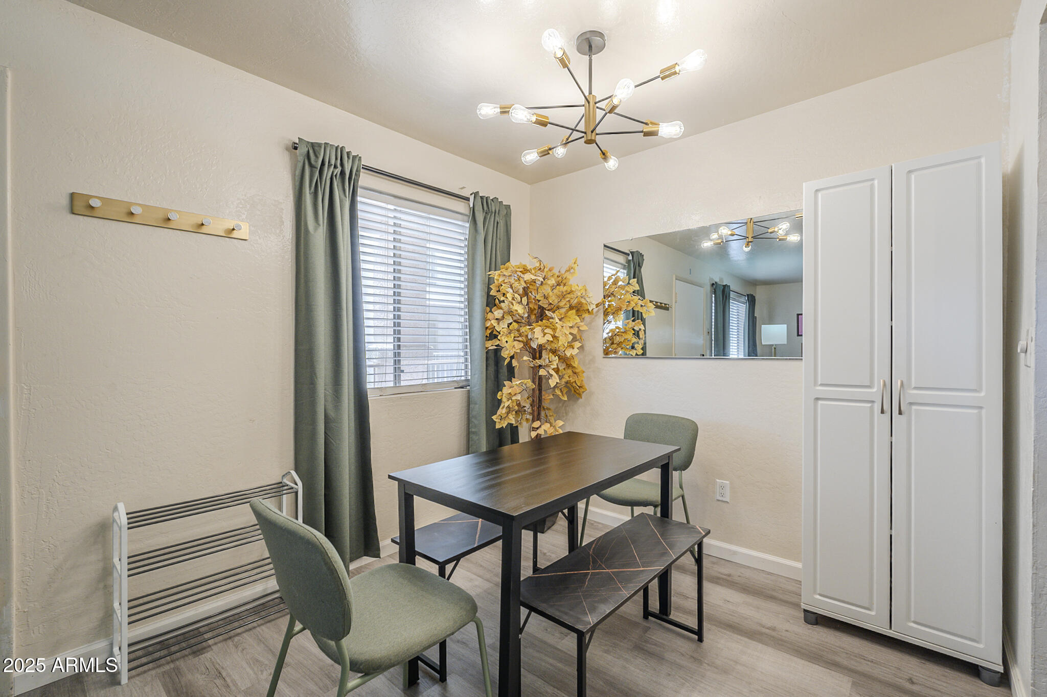 12123 West Bell Road, Unit 260 Surprise, AZ 85378 - Photo 8 of 29 a view of a dining room with furniture and wooden floor