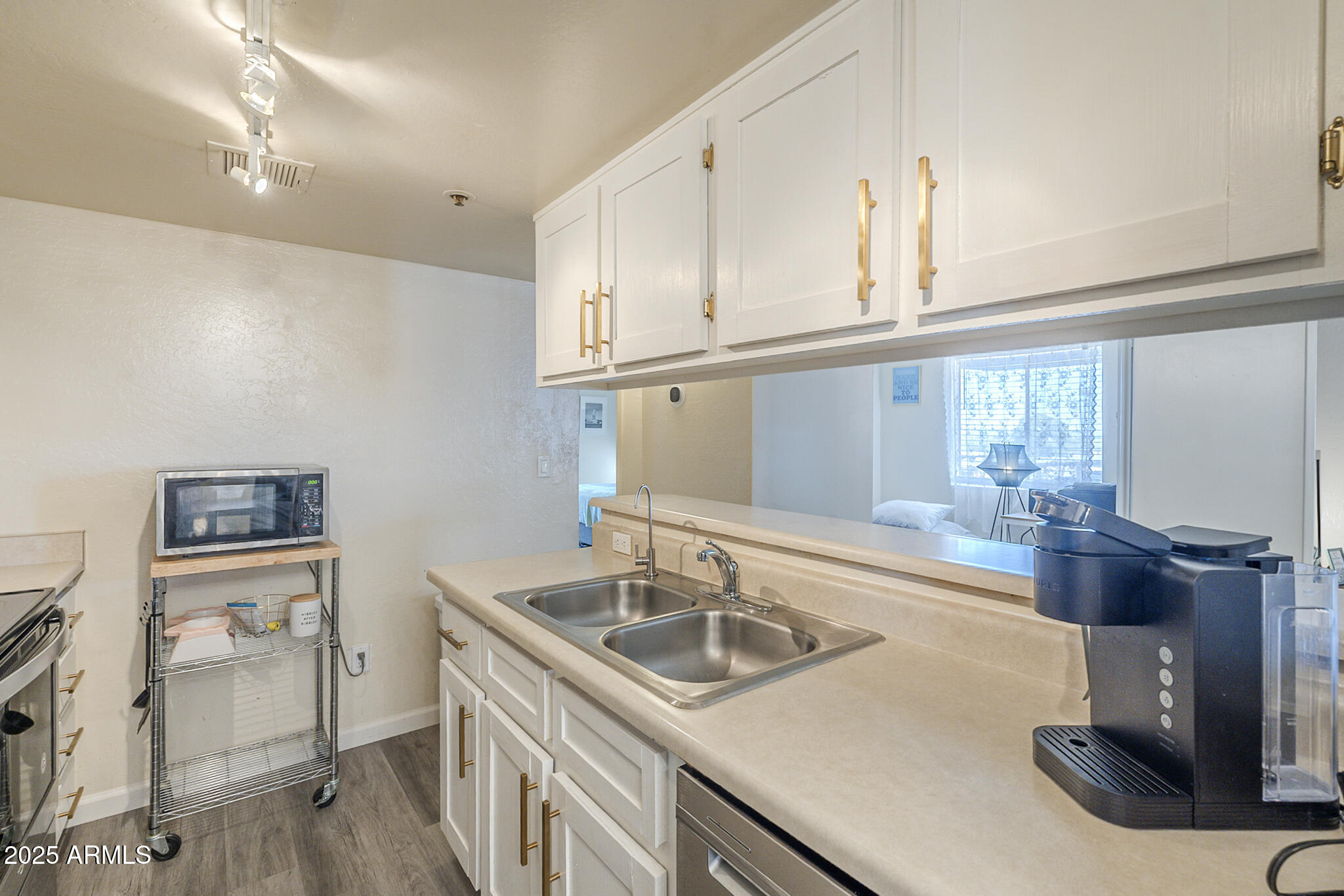12123 West Bell Road, Unit 260 Surprise, AZ 85378 - Photo 10 of 29 a kitchen with stainless steel appliances granite countertop a sink and a refrigerator