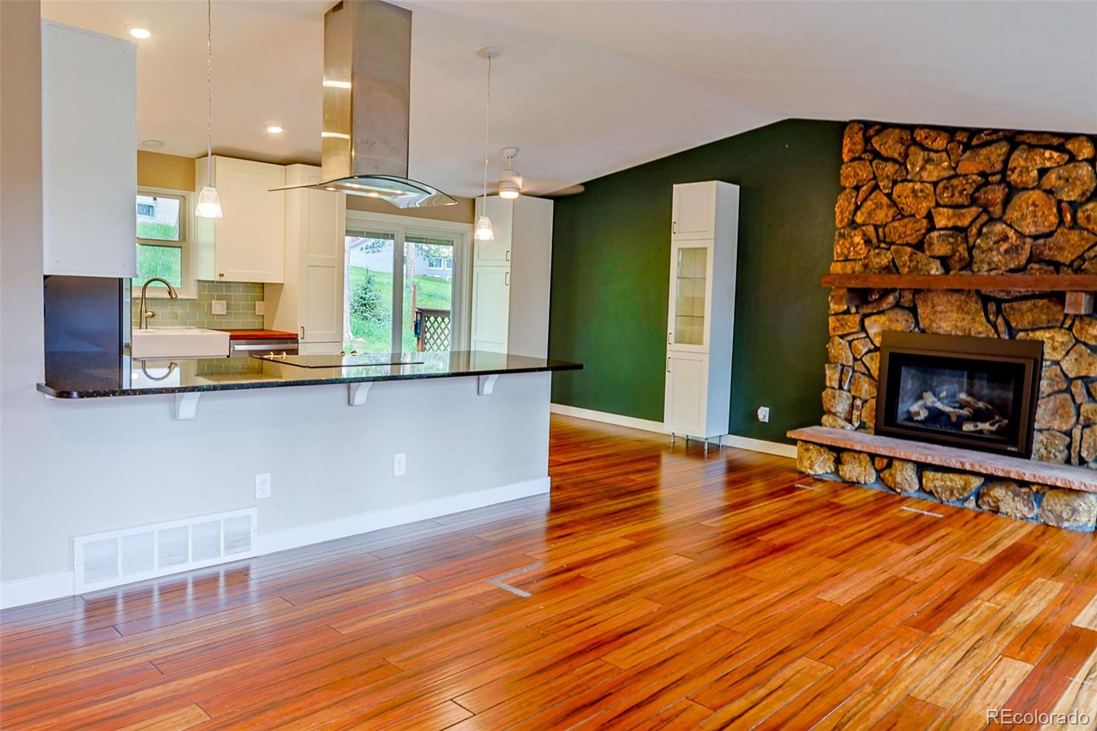 5237 South Olive Road Evergreen, CO 80439 - Photo 11 of 31 a view of a kitchen with furniture and a fireplace