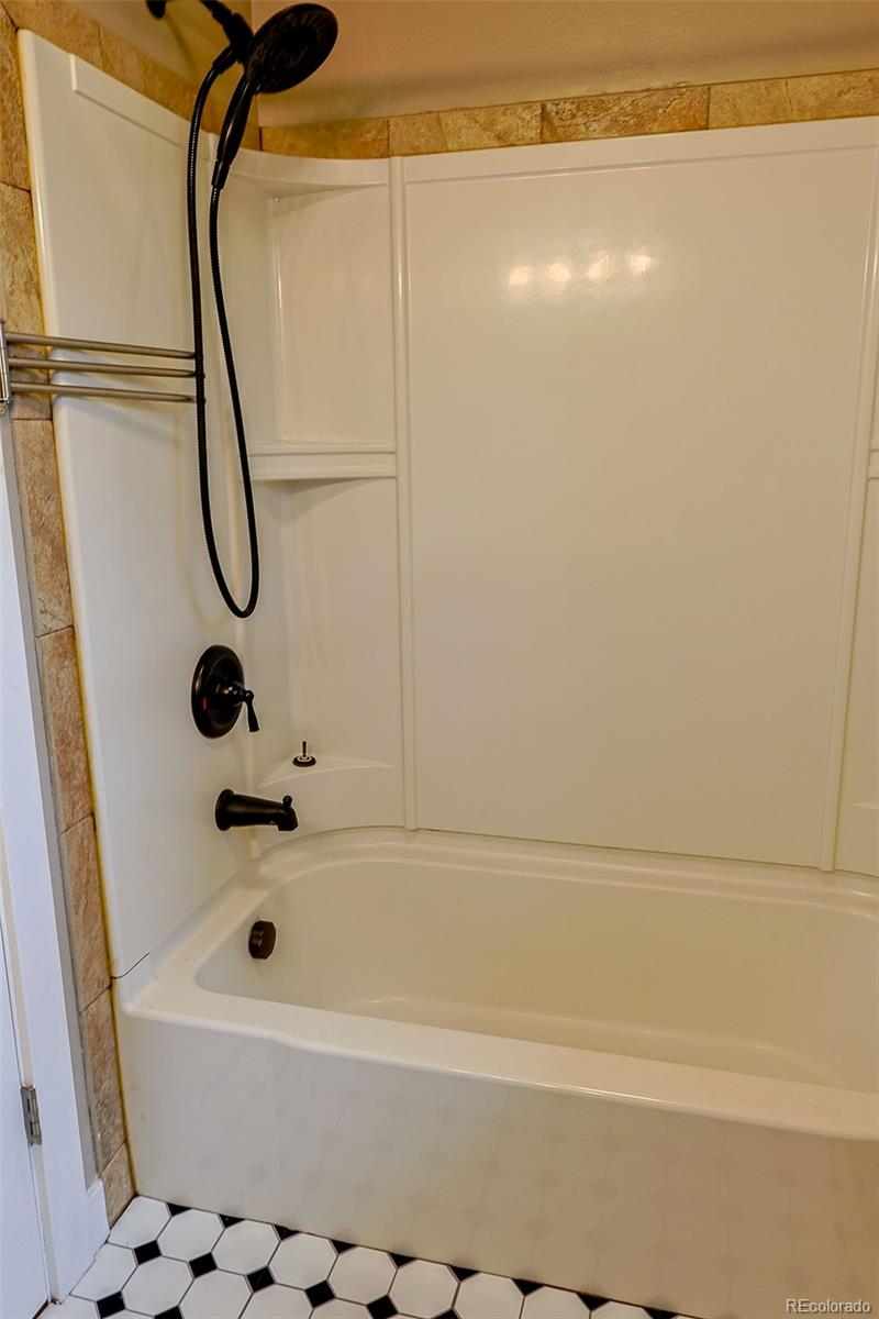 5237 South Olive Road Evergreen, CO 80439 - Photo 14 of 31 a bathroom with a bathtub and shower