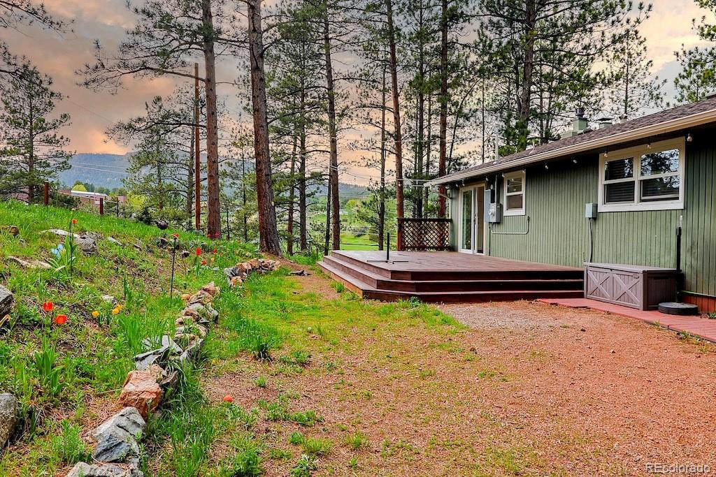 5237 South Olive Road Evergreen, CO 80439 - Photo 29 of 31 a backyard of a house with table and chairs