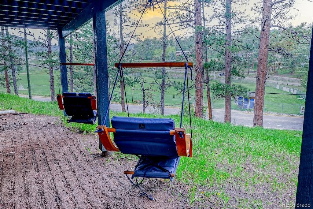 5237 South Olive Road Evergreen, CO 80439 - Photo 5 of 31 a garden view with a seating space