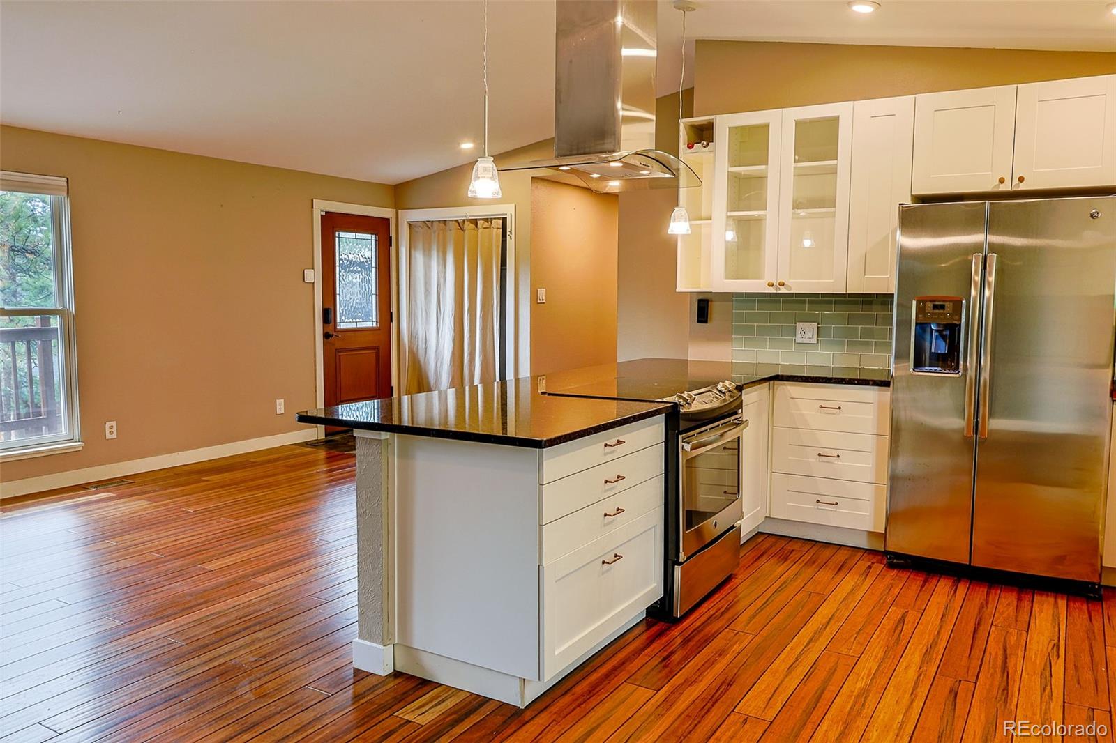 5237 South Olive Road Evergreen, CO 80439 - Photo 8 of 31 a kitchen with cabinets wooden floor and stainless steel appliances
