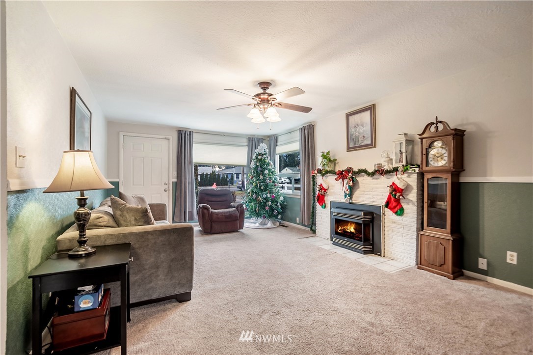 8216 Custer Road Southwest Lakewood, WA 98499 - Photo 2 of 20 a living room with furniture and a fireplace