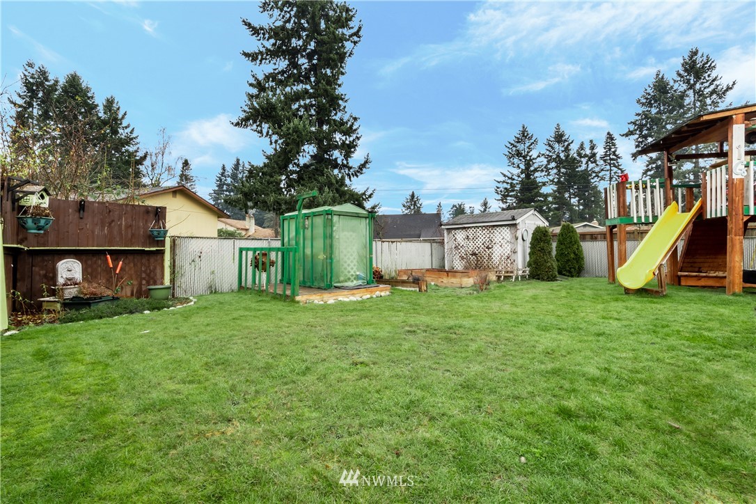 8216 Custer Road Southwest Lakewood, WA 98499 - Photo 13 of 20 a view of a house with backyard and a tree