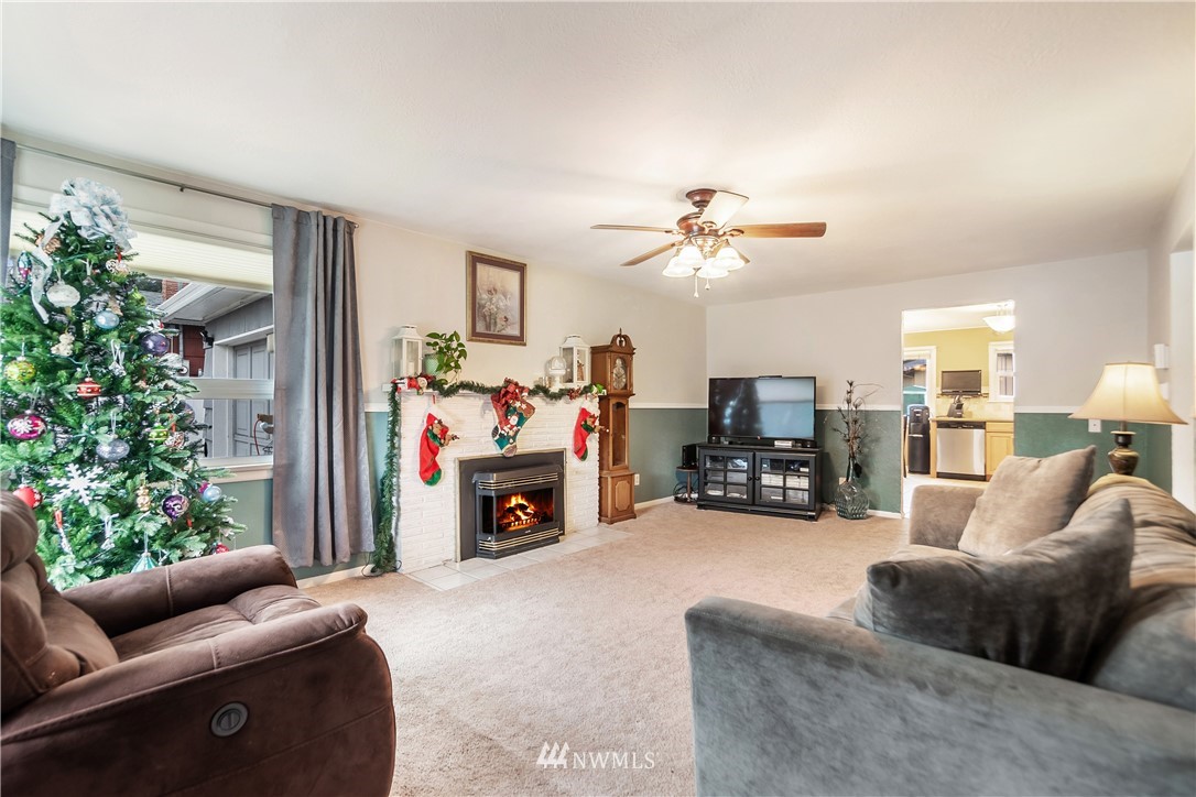 8216 Custer Road Southwest Lakewood, WA 98499 - Photo 3 of 20 a living room with furniture and a fireplace