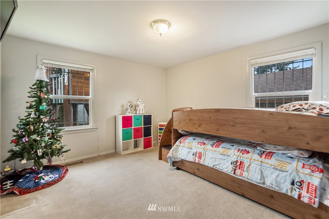 8216 Custer Road Southwest Lakewood, WA 98499 - Photo 10 of 20 a bedroom with a bed and a window