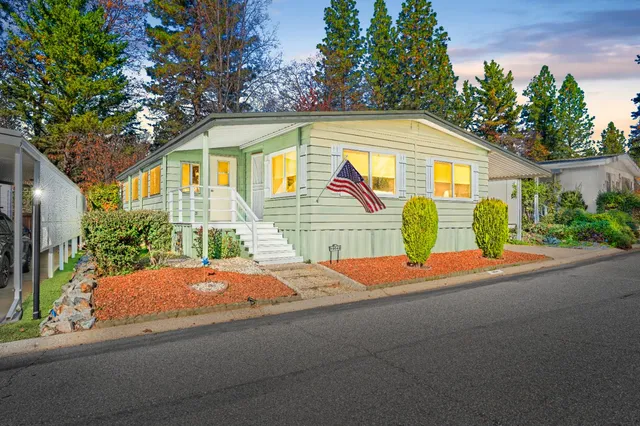 a backyard of a house with yard and outdoor seating
