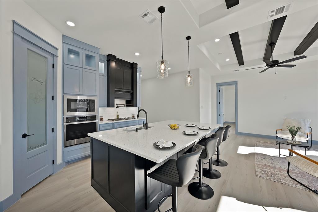 4754 Ramey Avenue Fort Worth, TX 76105 - Photo 11 of 31 a kitchen with a table chairs stainless steel appliances and cabinets