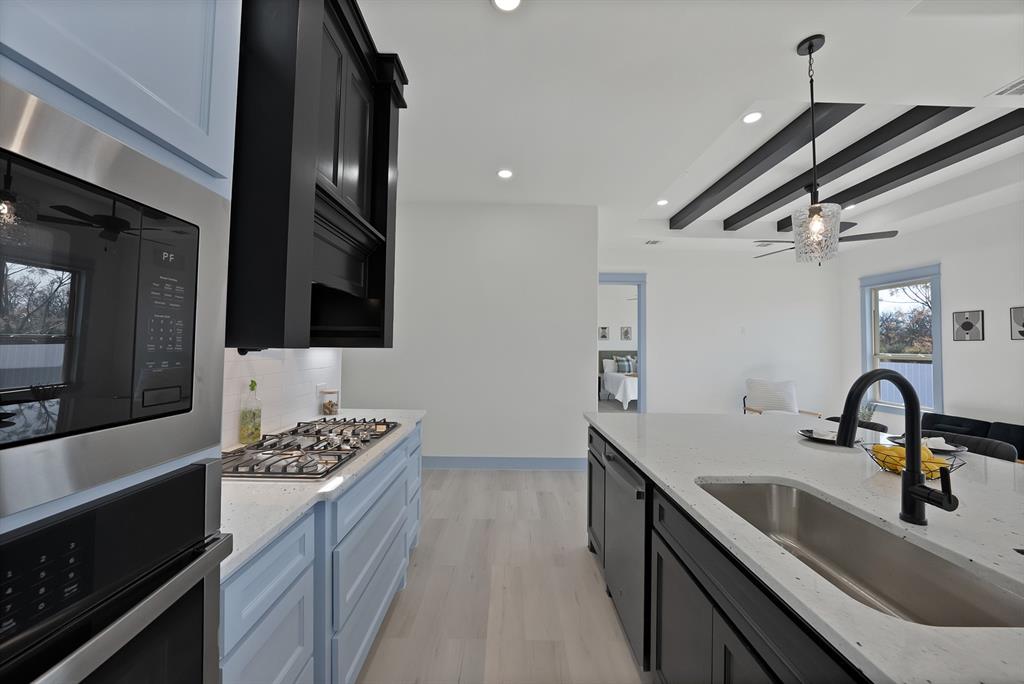 4754 Ramey Avenue Fort Worth, TX 76105 - Photo 12 of 31 a kitchen with a sink appliances and cabinets