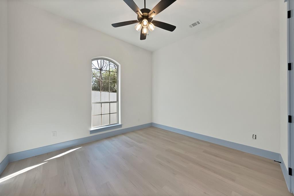 4754 Ramey Avenue Fort Worth, TX 76105 - Photo 20 of 31 an empty room with windows and fan