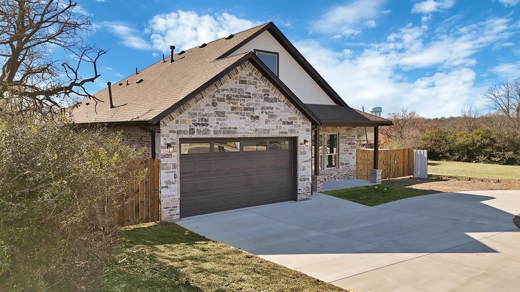 4754 Ramey Avenue Fort Worth, TX 76105 - Photo 3 of 31 a front view of a house with a yard and garage