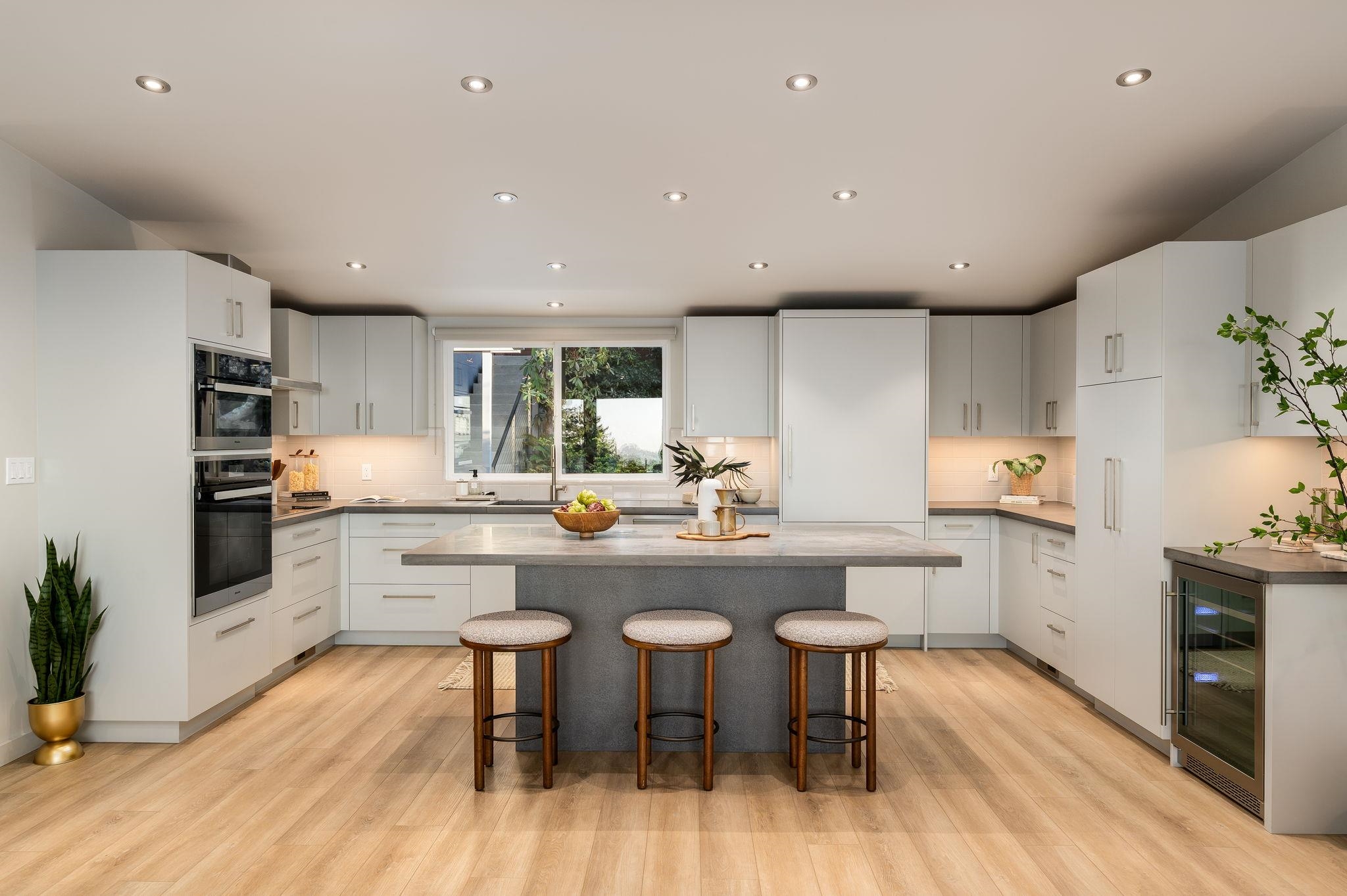1468 Summit Road Berkeley, CA 94708 - Photo 13 of 59 Kitchen with a breakfast bar, recessed lighting, white cabinetry, beverage cooler, and a kitchen island