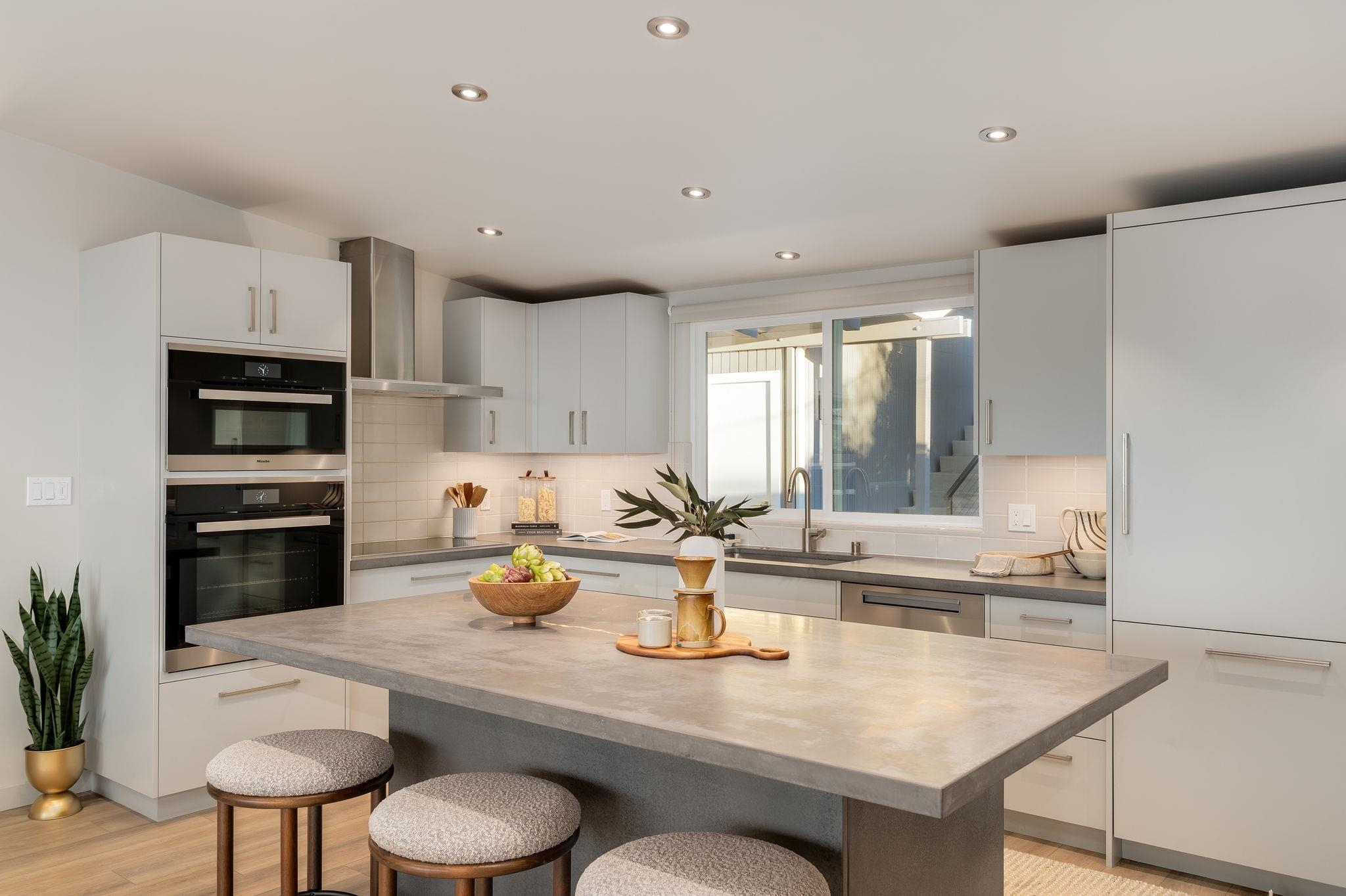 1468 Summit Road Berkeley, CA 94708 - Photo 15 of 59 Kitchen with a kitchen breakfast bar, stainless steel appliances, a kitchen island, recessed lighting, and light wood-style floors