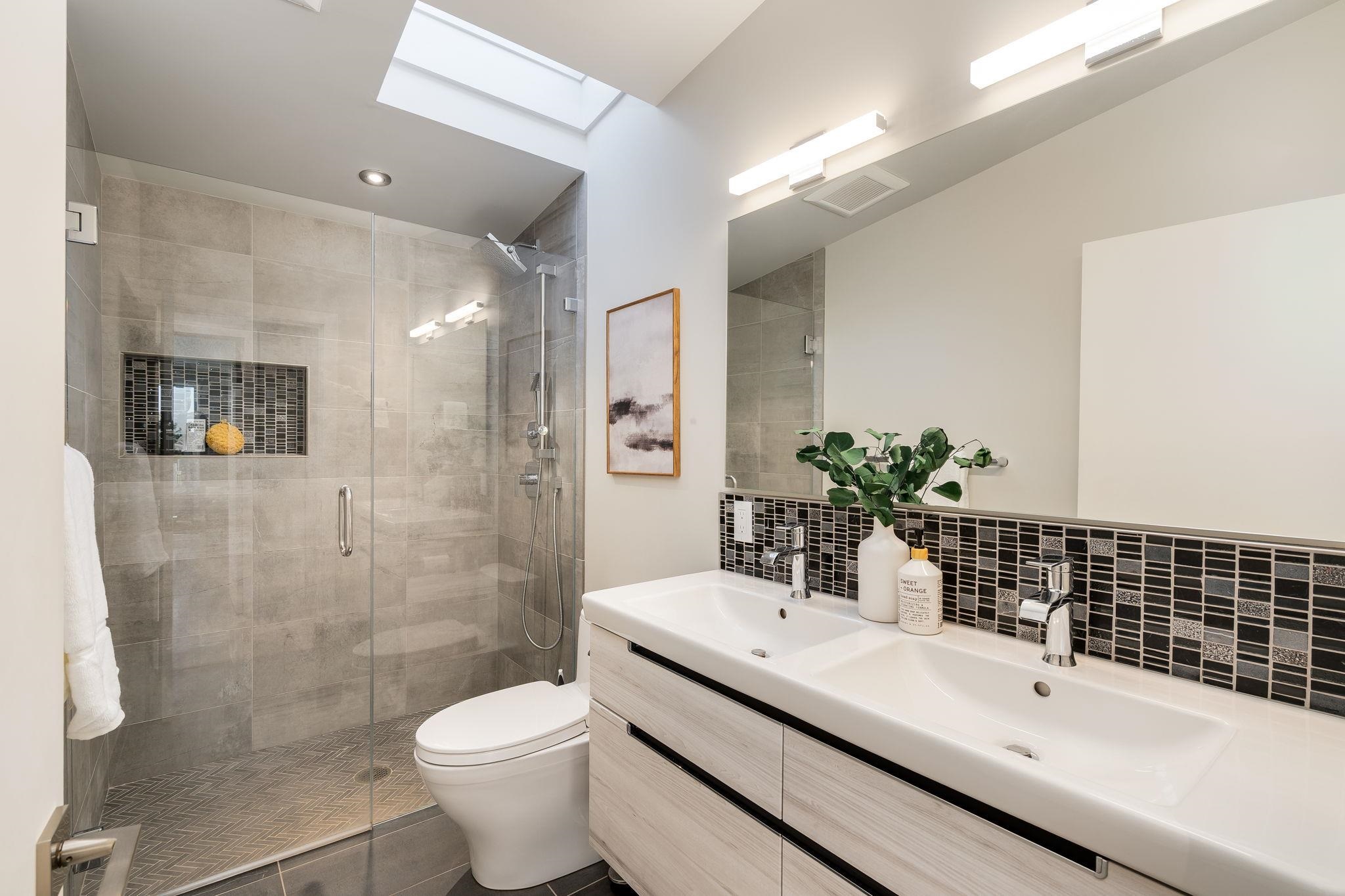 1468 Summit Road Berkeley, CA 94708 - Photo 22 of 59 Full bathroom with double vanity, a stall shower, decorative backsplash, and a skylight