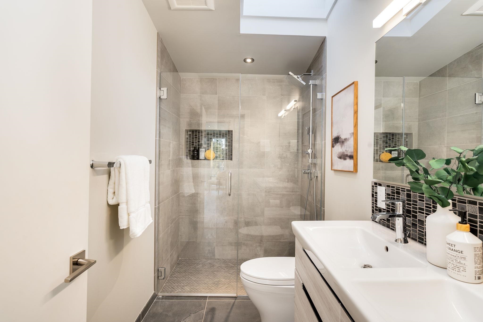 1468 Summit Road Berkeley, CA 94708 - Photo 23 of 59 Full bathroom featuring vanity, a shower stall, backsplash, and a skylight