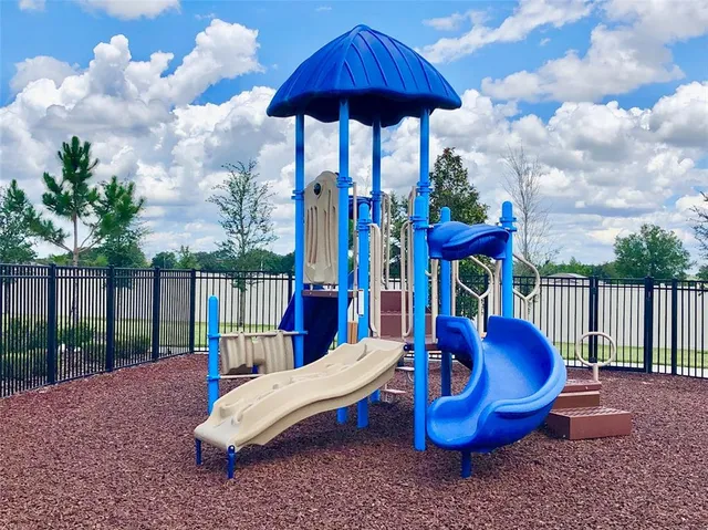 a view of a backyard with furniture and a garden