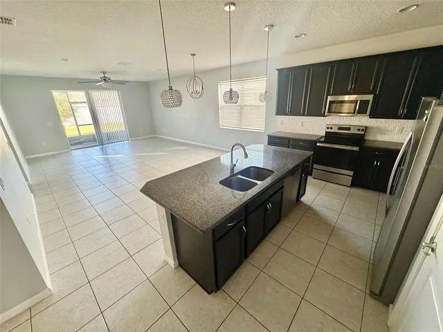 a kitchen with stainless steel appliances granite countertop a sink and a stove
