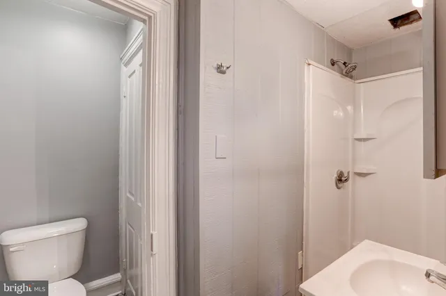 a bathroom with a toilet and a shower