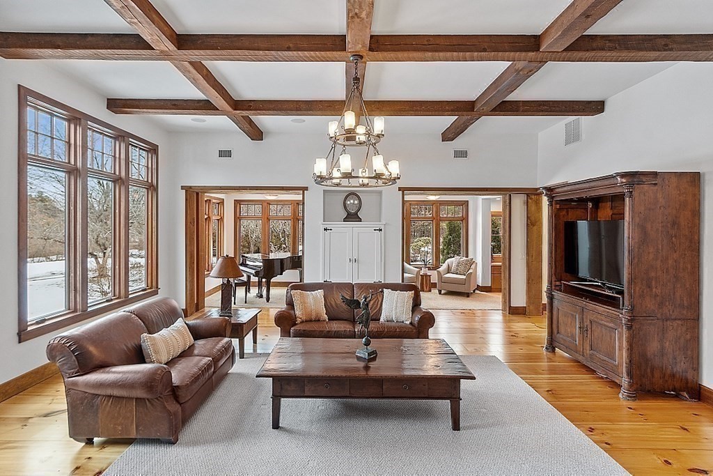 249 Dutton Road Sudbury, MA 01776 - Photo 18 of 40 a living room with fireplace furniture and a chandelier