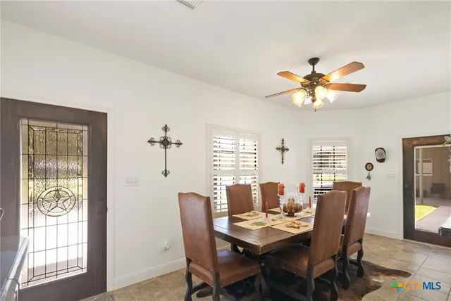 a living room with furniture a flat screen tv and a window