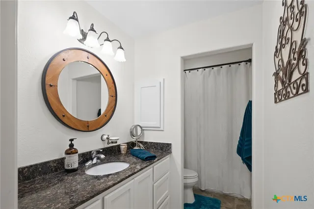 a spacious bathroom with a double vanity sink mirror and double