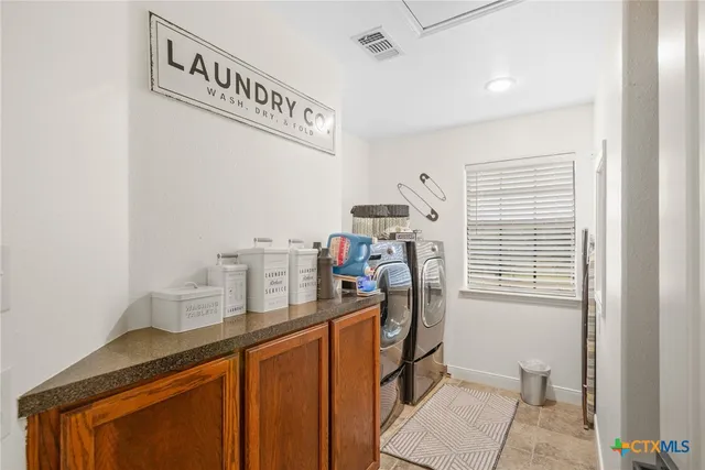 a kitchen with a stove sink and cabinets