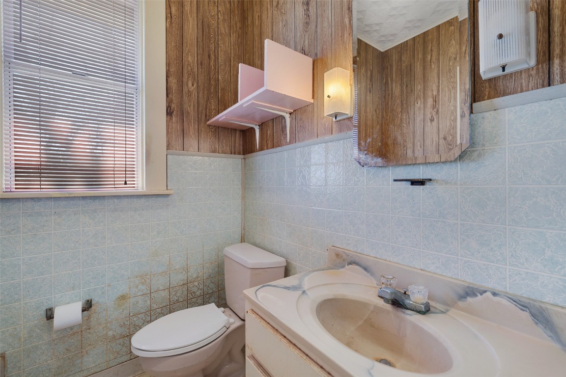 303 Vernon Street Taylor, TX 76574 - Photo 23 of 37 Half bathroom , vanity, and toilet