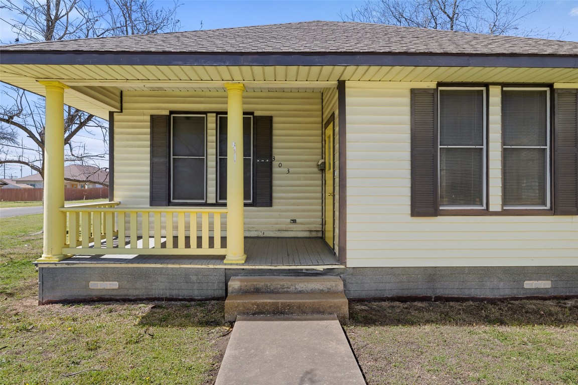 303 Vernon Street Taylor, TX 76574 - Photo 3 of 37 Doorway to property featuring crawl space, a shingled roof, and a porch