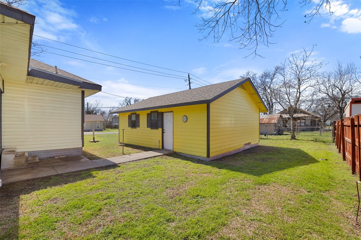 303 Vernon Street Taylor, TX 76574 - Photo 9 of 37 View of outdoor structure with an outbuilding and fence