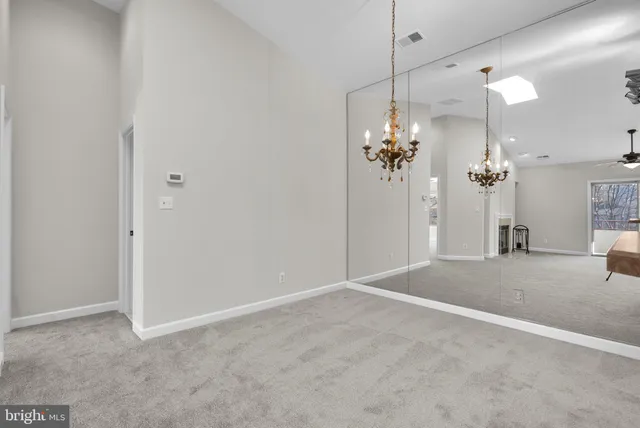 a view of a kitchen with a sink and dishwasher a refrigerator with wooden floor
