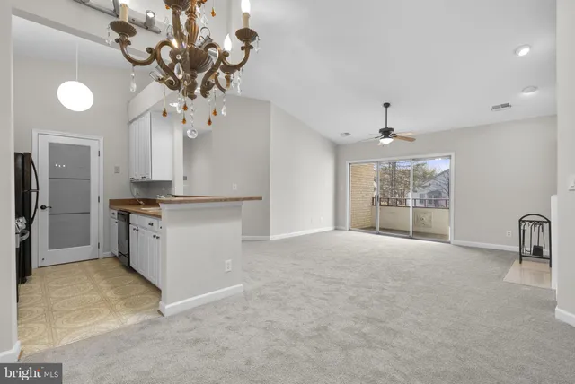 a kitchen with kitchen island a counter top space stainless steel appliances and cabinets