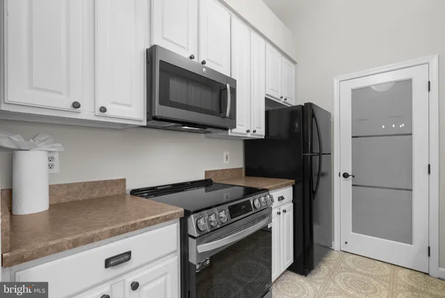 a kitchen with stainless steel appliances granite countertop a sink stove and microwave