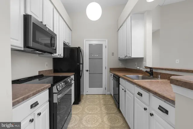 a kitchen with a sink cabinets and window