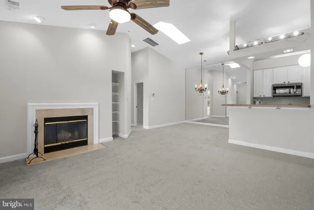 a view of a kitchen with a sink and a fireplace