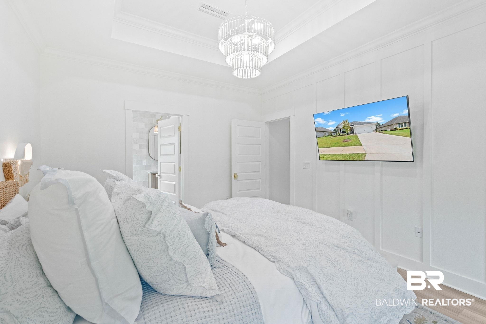 9815 Lakeview Drive Foley, AL 36535 - Photo 32 of 100 Bedroom featuring a chandelier, ornamental molding, connected bathroom, a tray ceiling, and light wood-type flooring
