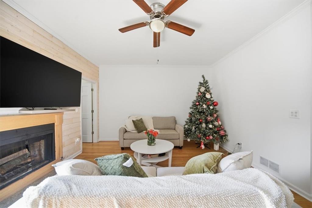 2215 Spring Walk Court Atlanta, GA 30341 - Photo 11 of 29 a living room with furniture a flat screen tv and a fireplace