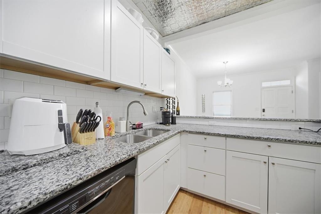 2215 Spring Walk Court Atlanta, GA 30341 - Photo 13 of 29 a kitchen with granite countertop white cabinets and white appliances