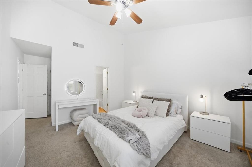 2215 Spring Walk Court Atlanta, GA 30341 - Photo 17 of 29 a bedroom with a bed and a chandelier