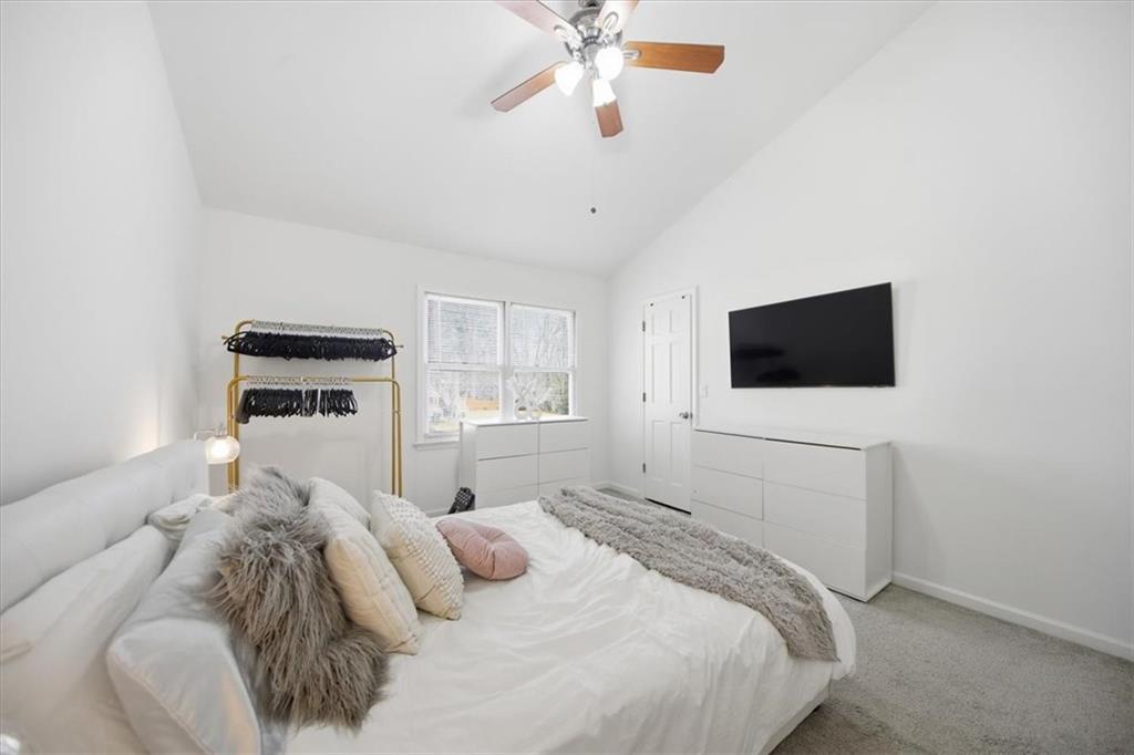 2215 Spring Walk Court Atlanta, GA 30341 - Photo 18 of 29 a bedroom with a bed and a flat screen tv