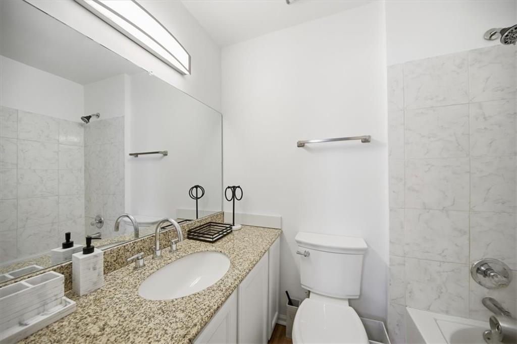 2215 Spring Walk Court Atlanta, GA 30341 - Photo 19 of 29 a bathroom with a granite countertop sink mirror vanity and toilet