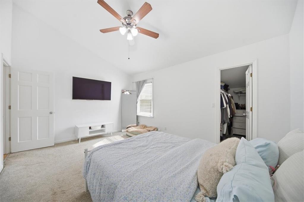 2215 Spring Walk Court Atlanta, GA 30341 - Photo 22 of 29 a bedroom with a bed and a chandelier