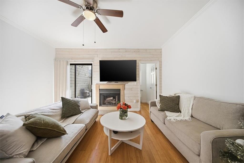 2215 Spring Walk Court Atlanta, GA 30341 - Photo 9 of 29 a living room with furniture a fireplace and a flat screen tv