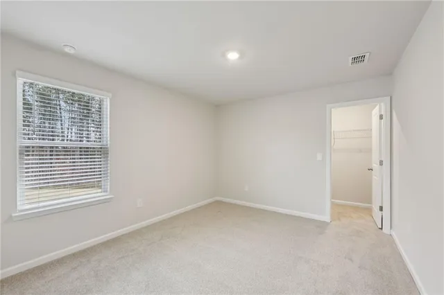 a view of a room with a large window and a bed