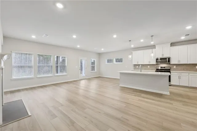 a kitchen with granite countertop white cabinets and white appliances