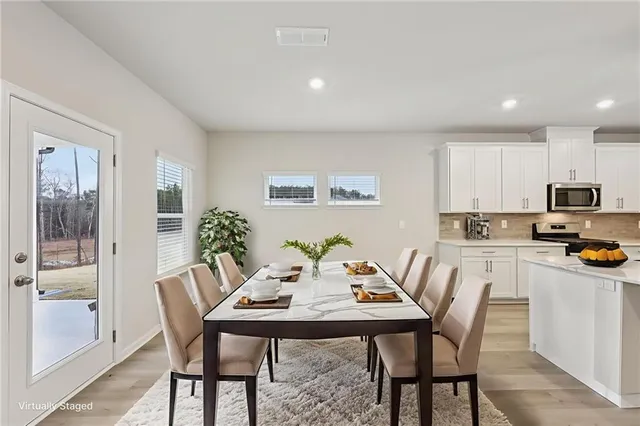 a kitchen with white cabinets sink and stainless steel appliances