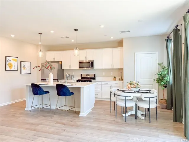 a kitchen with sink stove and wooden floor