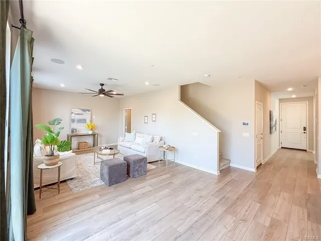 a living room with furniture and a potted plant