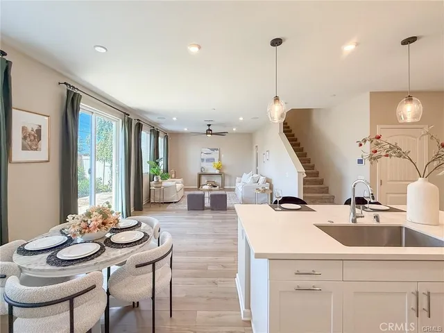 a living room with furniture and kitchen view